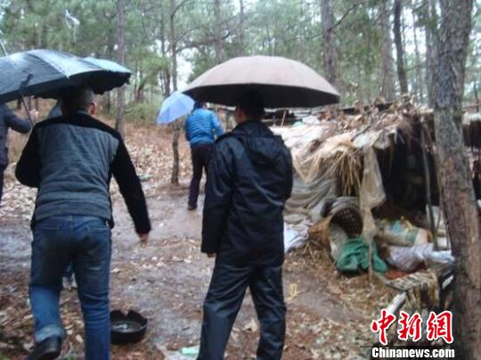 图为民警带领刘某弟弟来到刘某的窝棚　杨乔云　摄