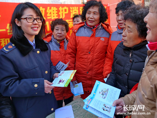 工作人员发放消费者权益保护宣传材料。